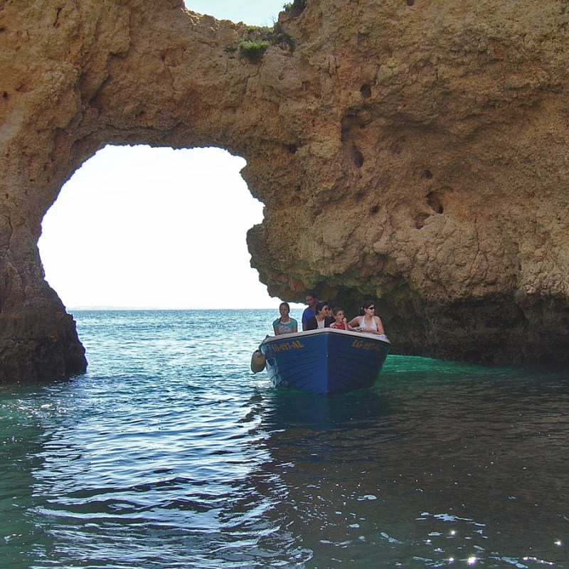 a person sitting on a rock next to water