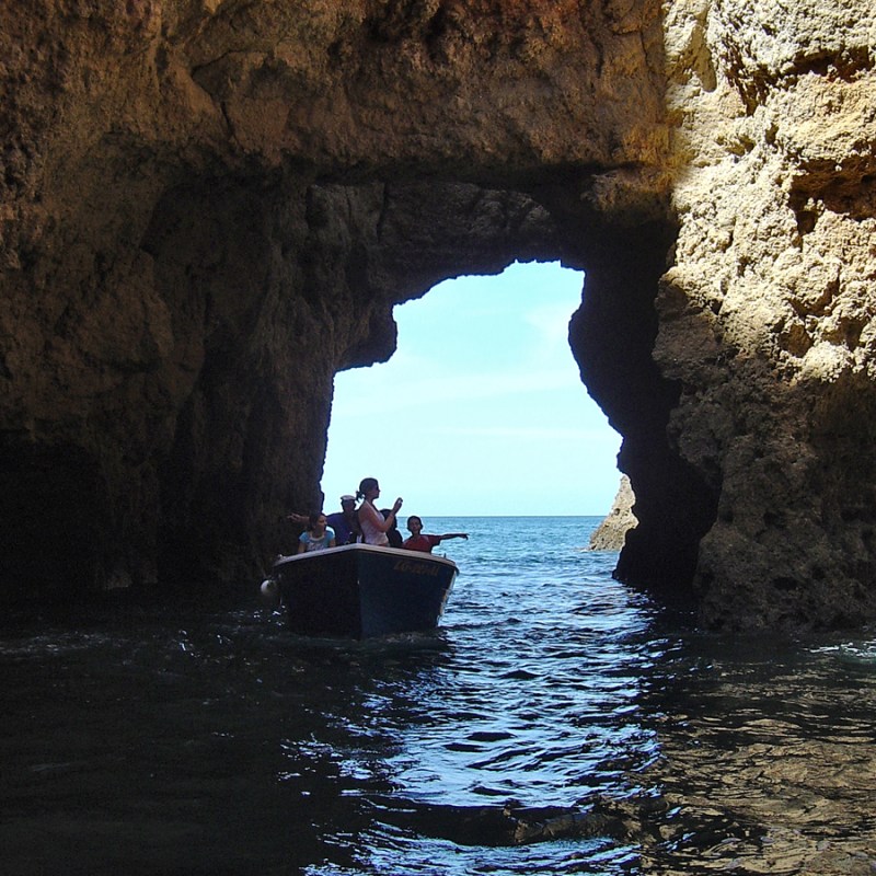 a cave next to a body of water