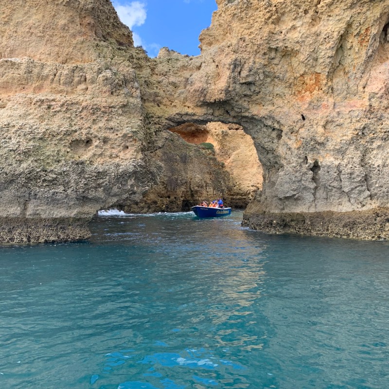 a person sitting on a rock next to water