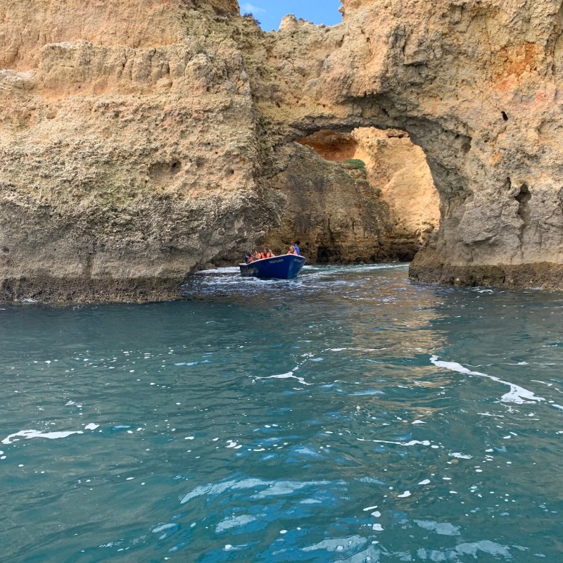 a person sitting on a rock next to water