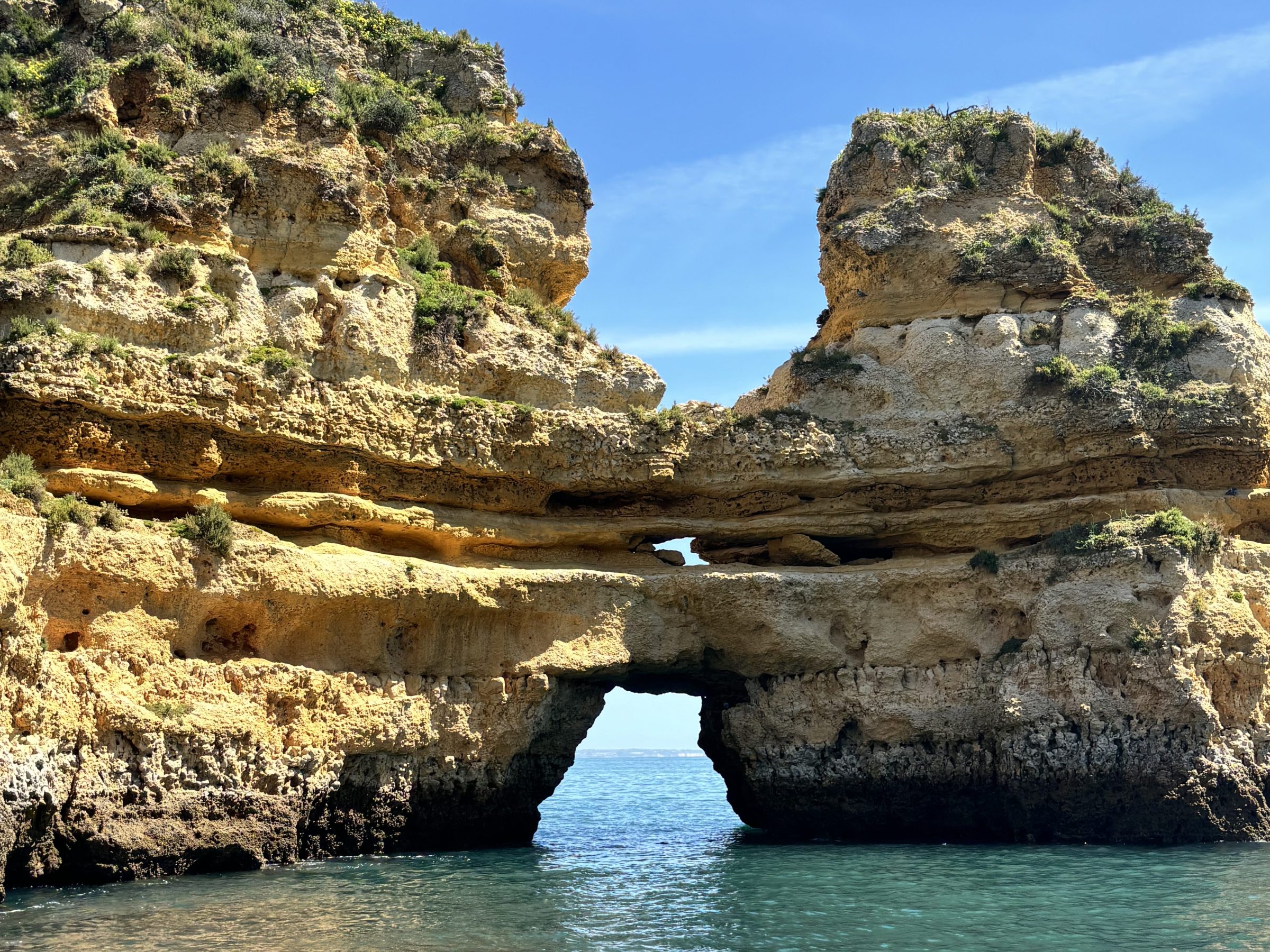 a person sitting on a rock near the ocean