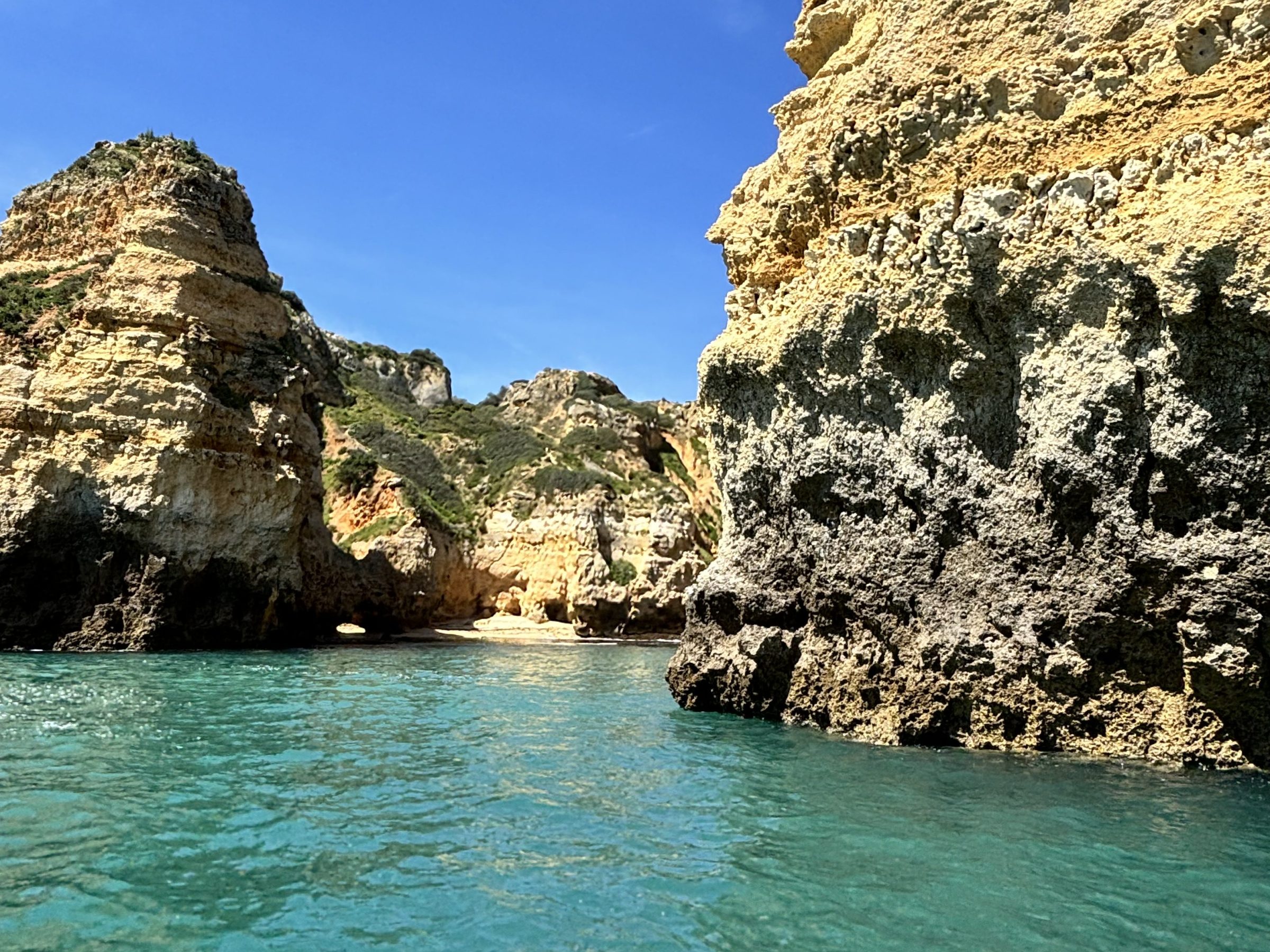 a rocky island in the middle of a body of water